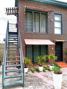a house with a staircase in front of it at Kalo Shipping Container in Christiansborg