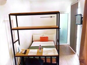 a small room with a bunk bed and a desk at Kalo Shipping Container in Christiansborg
