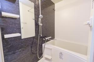 a bathroom with a shower with a sink and a toilet at 20 min to Nagoya Station Luxury Apt 4pax 2 1bed in Nagoya +31 photos