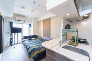 a kitchen with a sink and a bed in a room at 20 min to Nagoya Station Luxury Apt 4pax 2 1bed in Nagoya