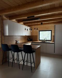 a kitchen with a table and chairs in it at Villa Alba in Kupres