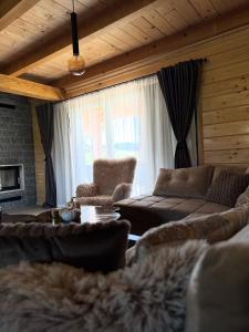 a living room with a couch and a table at Villa Alba in Kupres
