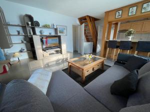 a living room with a couch and a coffee table at Fewo 4 OG Sylt Westerland in Süderende