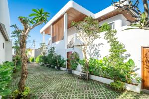 an exterior view of a house with trees and plants at Sanur Paradise - Brand New 3BR Villa - Private Pool - Beach Access in Sanur