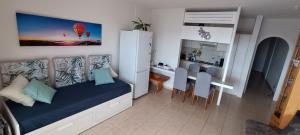 a small room with a bed and a dining room at Ladybug Ocean View in Costa Del Silencio