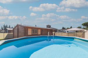 a swimming pool in front of a house at Bungalow Luna in Chiclana de la Frontera
