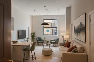 a living room with a couch and a table at Paramount Stays - Uxbridge in Uxbridge
