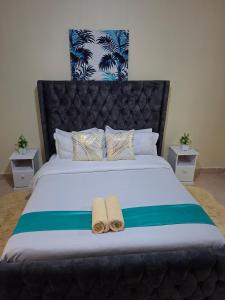 a bedroom with a bed with two towels on it at Lakeview Elegance in Nakuru +4 photos