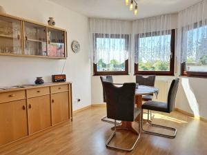 a kitchen with a table and chairs in a room at Baltique - Ferienwohnung 1 Glowe in Glowe