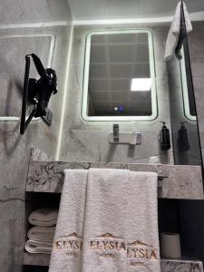 a bathroom with a sink with a mirror and towels at Elysia Hotel in Istanbul +39 photos