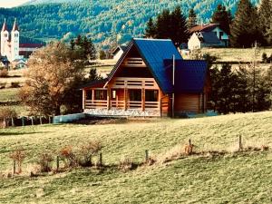 a log cabin on a hill in a field at Villa Alba in Kupres