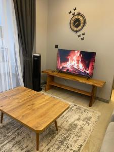 a living room with a table and a television on a table at Mert house 19 in Atakum +2 photos