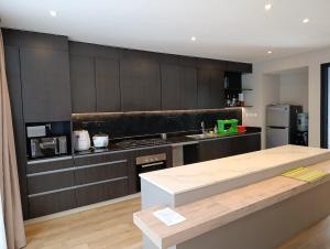 a kitchen with black cabinets and a counter top at Ineza Runda luxury exclusive in Kiambu