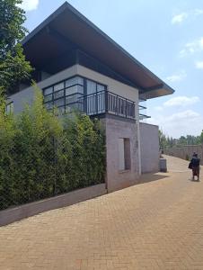 a building with a balcony on the side of it at Ineza Runda luxury exclusive in Kiambu