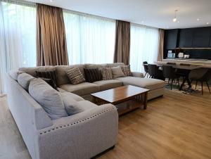 a living room with a couch and a piano at Ineza Runda luxury exclusive in Kiambu