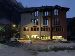 a large building with lights in the windows at Kulla Emini Valbone 2025 in Valbonë