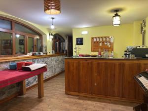 a bar in a restaurant with a red bench in front at Kulla Emini Valbone 2025 in Valbonë