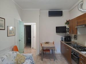 a kitchen with a table and a small kitchen with a couch at Apartment Silvia-Metro Rivoli&Free Private Parking in Turin