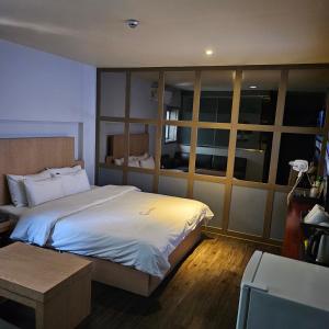 a bedroom with a large bed and a table at Guri C Boutique Hotel in Guri