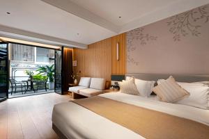 a bedroom with a bed and a living room at Jingjie Garden Holiday Homestay in Dali +170 photos