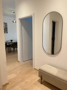 a mirror on a wall in a living room at Urban Vibe by Atlas Apartment in Prešov +8 photos