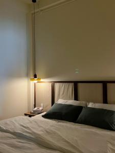 a bedroom with a bed and a table with a lamp at ngôi nhà vui vẻ á đông quận 1 60m2 in Ho Chi Minh City