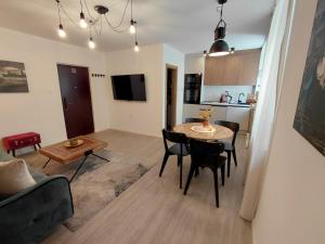 a living room and kitchen with a table and chairs at Four Seasons in Rijeka