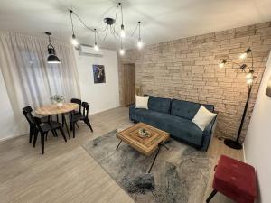 a living room with a couch and a table at Four Seasons in Rijeka