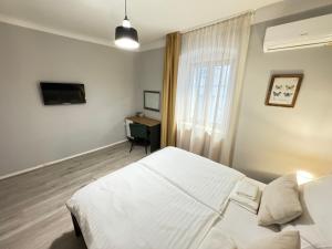 a bedroom with a white bed and a window at Four Seasons in Rijeka +18 photos