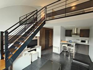 a staircase in a house with a living room at Hotel Bô Rivage in Neufchâteau