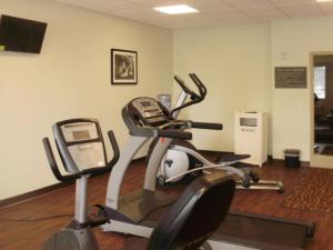 a room with a gym with a phone on a treadmill at Sleep Inn & Suites East Syracuse in East Syracuse