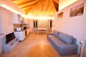 a large living room with a couch and a kitchen at Villa Il Circolo Bassone in Pontremoli
