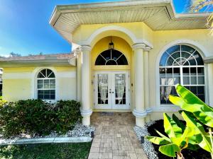 a yellow house with a white door at Villa Malibu in Cape Coral Hospital Heliport