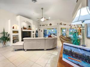 a living room with a white couch and a tv at Villa Malibu in Cape Coral Hospital Heliport +27 photos