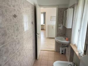 a bathroom with a sink and a toilet at SUITE DOLOMITI Appartamento in Falcade +28 photos