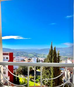 a view of a city from a balcony at Chauen White Pearl Apartments in Chefchaouene