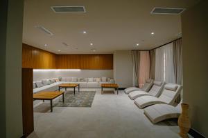 a waiting room with white couches and tables at Fabulous Studio at stunning Palmera Resort on Medditerranean coast in Karavas +22 photos