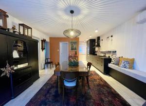 a kitchen and dining room with a table and a dining room at Fotel Dunakanyar in Nagymaros