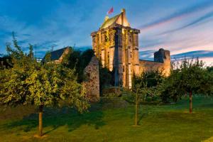 an old castle with trees in front of it at Chateau Le Vieil Etang in Saint-Sauveur-le-Vicomte +10 photos