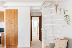 a staircase in a living room with white walls at Casa Majú - Algarve in Valados