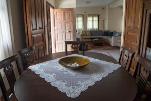a dining room table with a bowl on a white table cloth at Villa Maria Amalia in Tsagarada