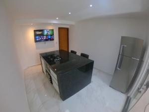 Μια τηλεόραση ή/και κέντρο ψυχαγωγίας στο TH Flats 101 com Banheira de Hidromassagem