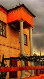 a building with two columns on the side of it at Phumelela Guesthouse in Trompsburg