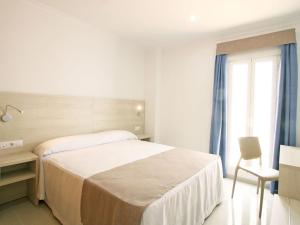 Postel nebo postele na pokoji v ubytování AReH Apartamentos