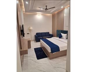 a bedroom with a bed and a couch at Shree Aaradhya Suites in Khātu