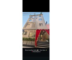 a building with a red banner in front of it at Shree Aaradhya Suites in Khātu