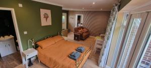 a bedroom with a bed and a living room at Fern Studio in Lyme Regis