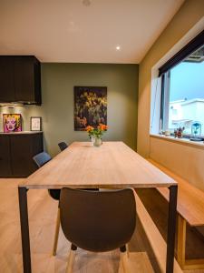a dining room with a table and a vase of flowers at Central apartment in Tromsø +25 photos