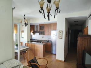 a kitchen with a table and a refrigerator at Mar de Rubite in Castillo de BaÃ±os