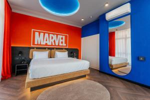 a bedroom with a large bed with a marvel sign on the wall at Spatium Medical & Wellness Hotel in Odesa +49 photos